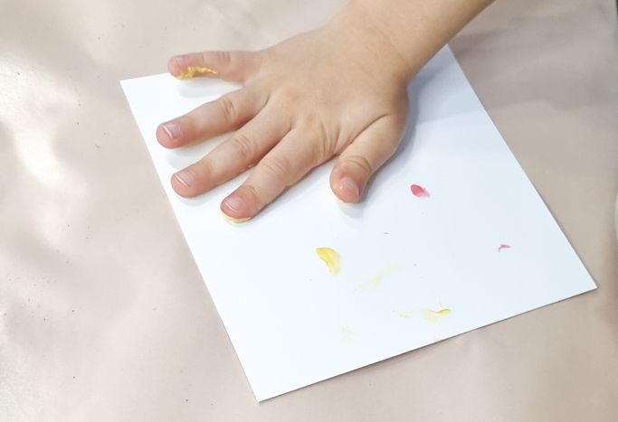 4. Für die Handabdrücke die Hand vom Kind mit der gewünschten Farbe einfärben.